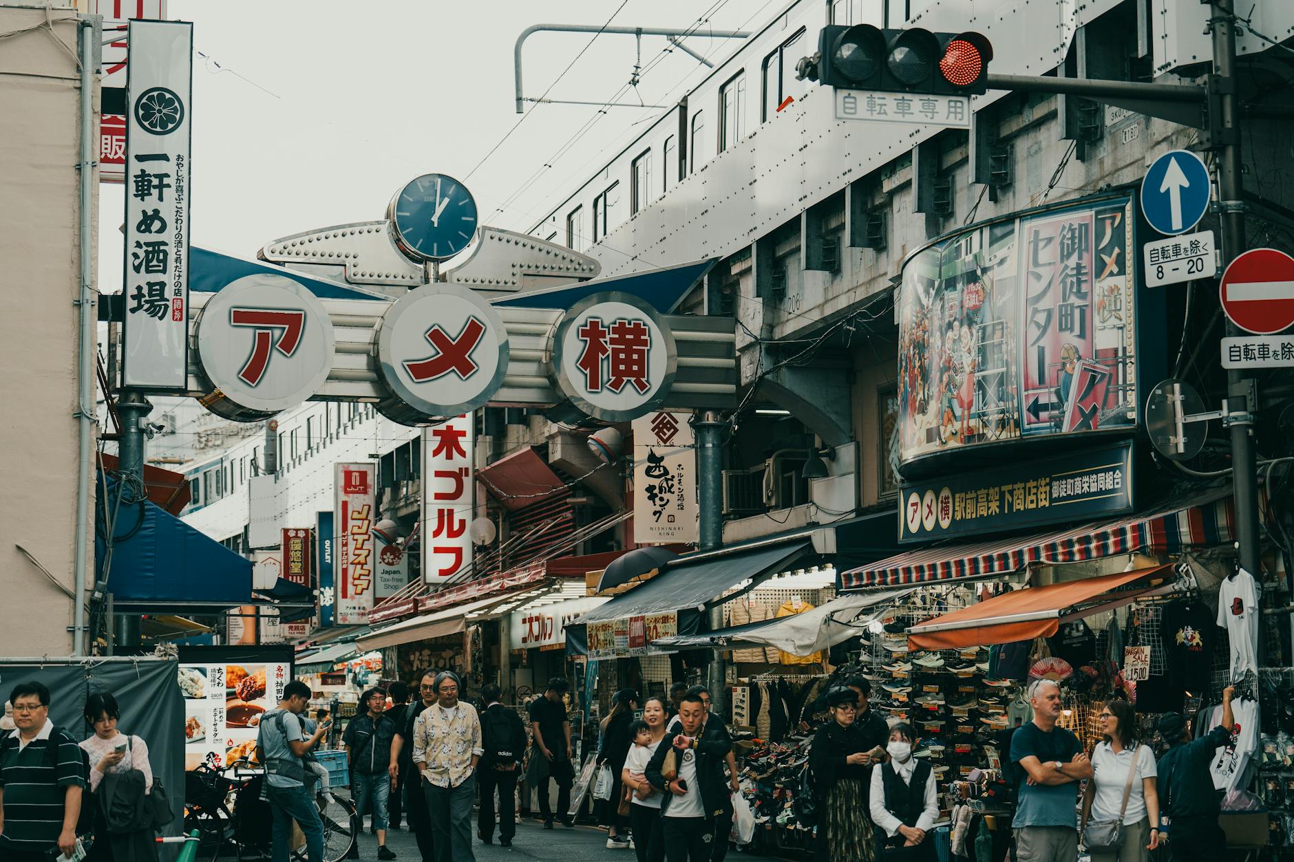 Bustling Ameyoko Market in Tokyo with shoppers browsing stalls on a sunny day