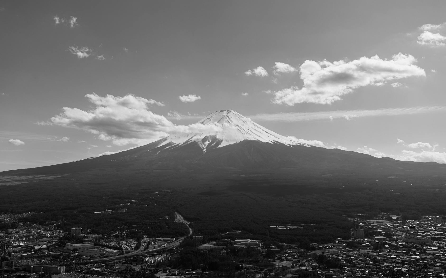 Dramatic aerial black and white view of Mount Fuji under clouds Japan