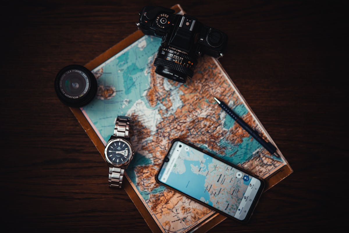 Travel essentials flat lay with map camera smartphone and passport for Japan trip planning