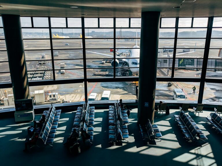 Spacious Tokyo airport terminal with view of airplane on the tarmac through glass windows