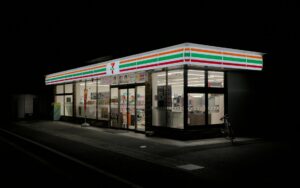 Brightly lit Japanese convenience store at night in Kyoto, Japan