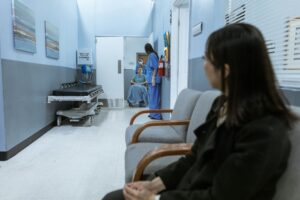 Hospital corridor with nurse assisting a patient in a wheelchair, representing healthcare and travel insurance in Japan
